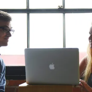 Man and woman working on a laptop together