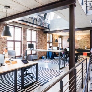 Man walking down stairs in industrial looking office space